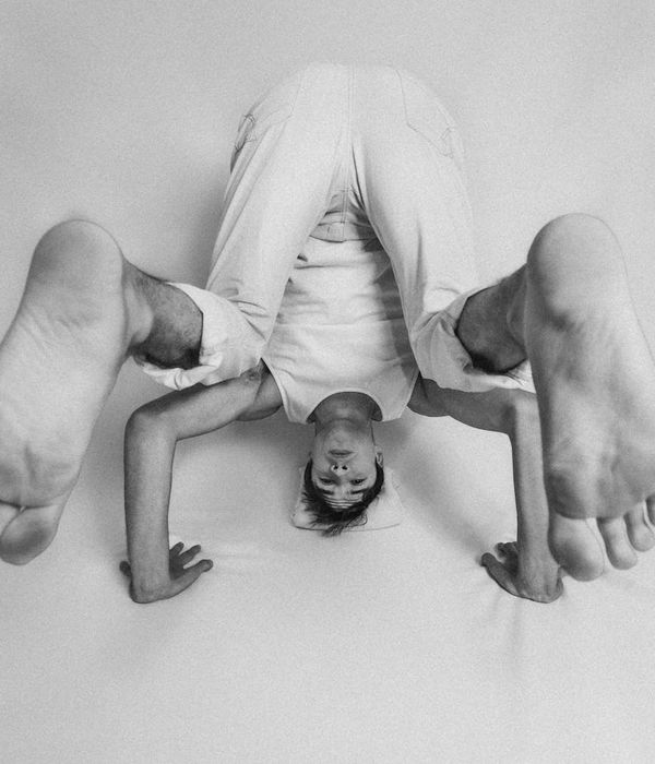Man in a meditative pose after a workout session, looking focused.